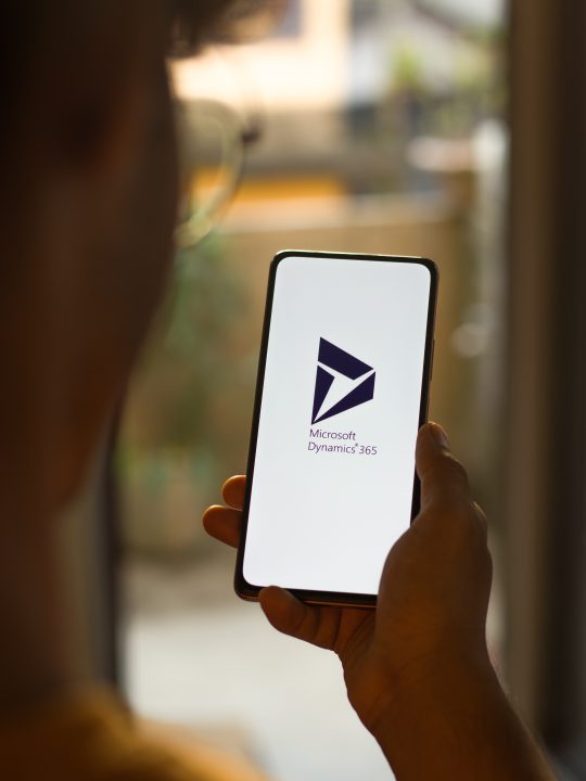 Microsoft Dynamics 365 logo on phone screen stock image.